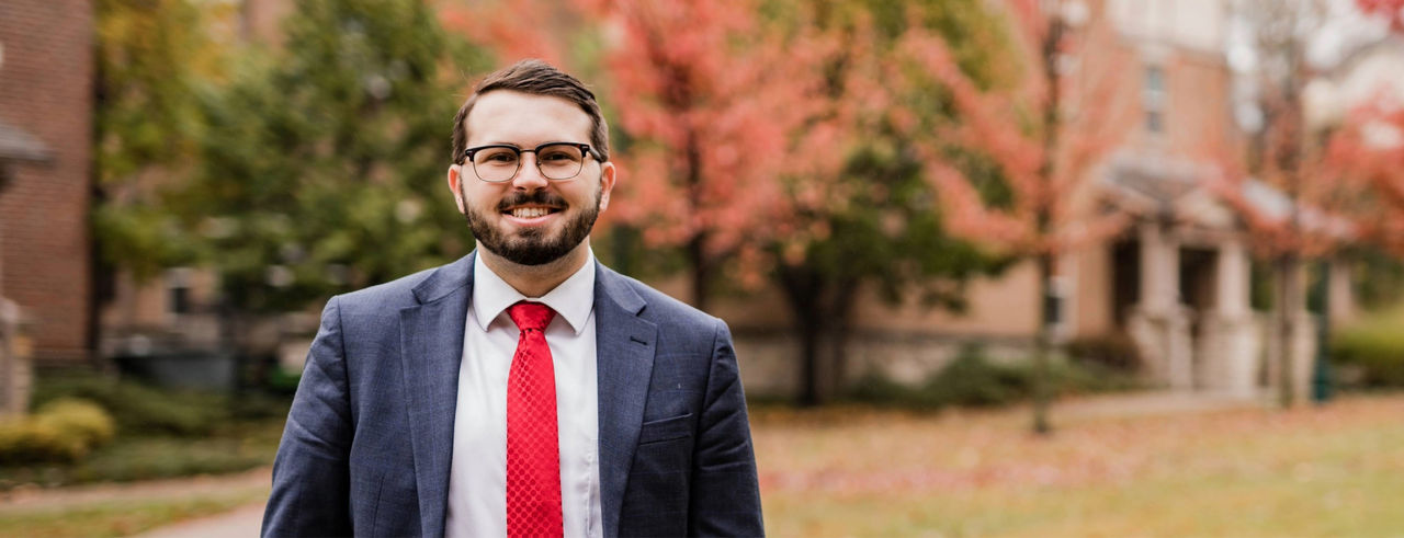 Logan Lindsay, former UC Student Body President, poses outside a campus building.