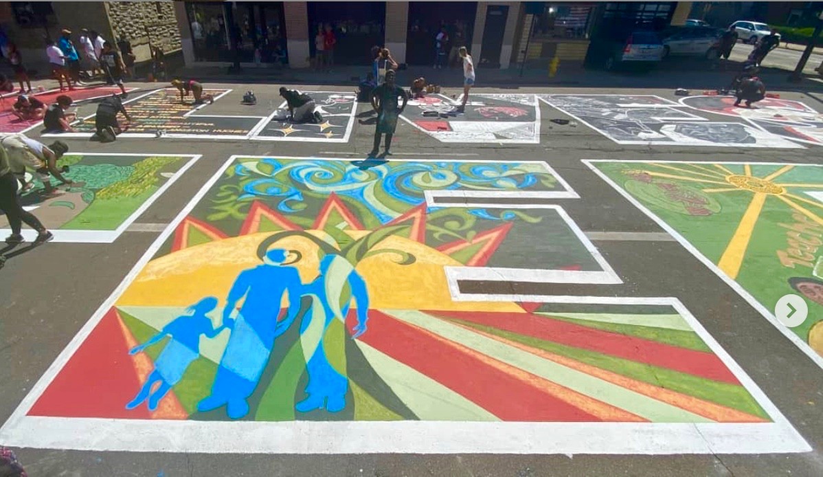 A large block letter E filled with colorful designs is part of Cincinnati's Black Lives Matter! street mural.