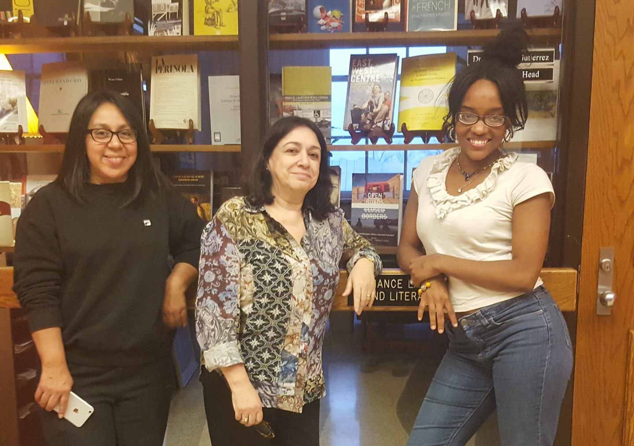 Tiffanie Clark and her friends pose in a UC hallway.