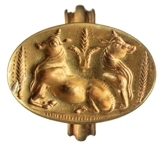 A gold ring features an iconic image of two bulls amid sheaves of barley.