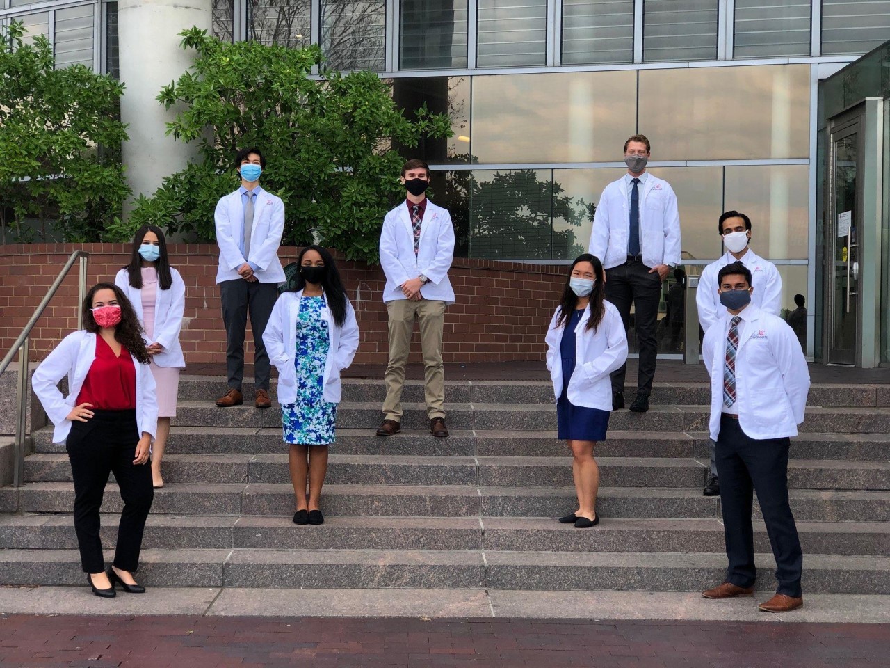 A group of incoming first-year medical students pose with masks and appropriate social distancing in front for the UC College of Medicine.
