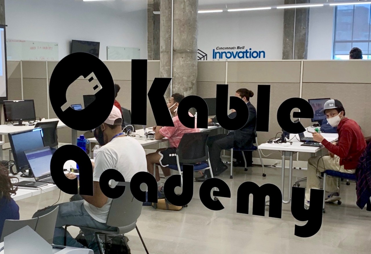 Kable Academy students in UC's 1819 Innovation Hub sit at desks wearing COVID-19 PPE masks.