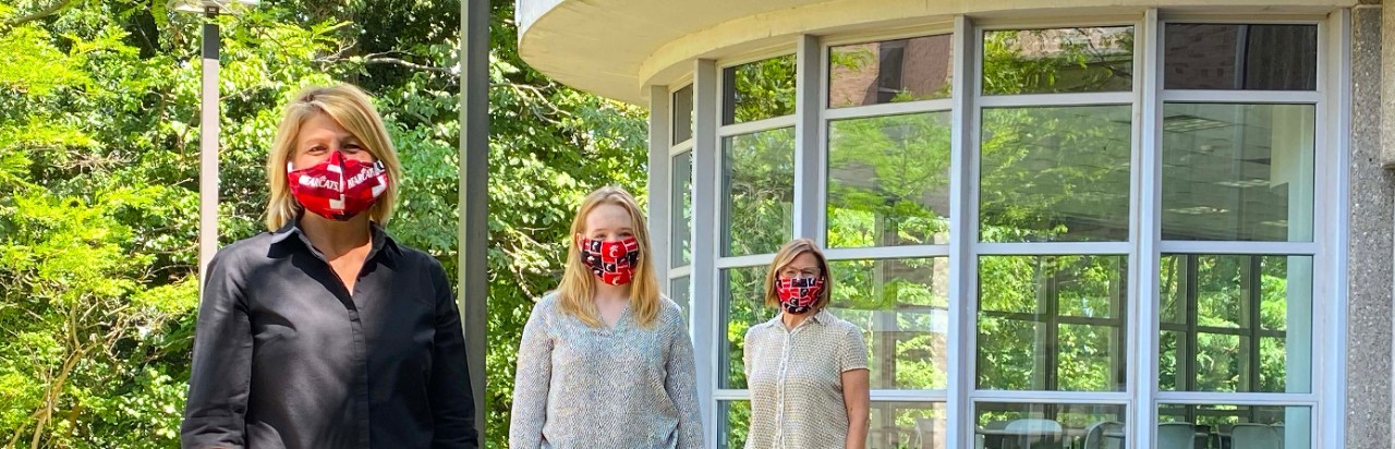Communiversity staff standing outside of the campus cafe building