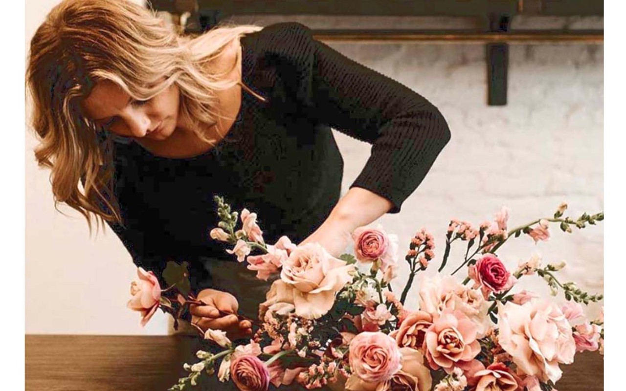 Woman making floral arrangement