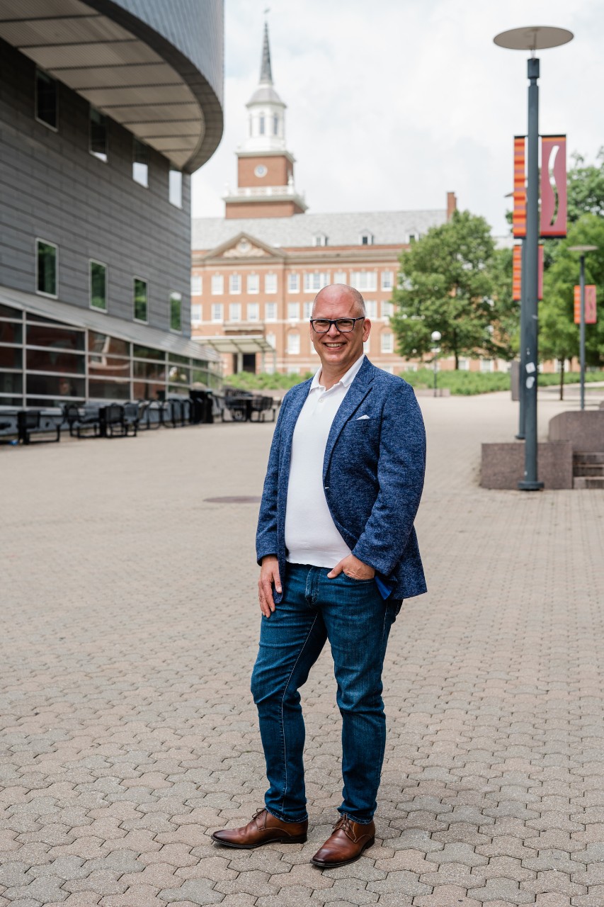 a portrait of Jim standing on Main Street on UC's campus