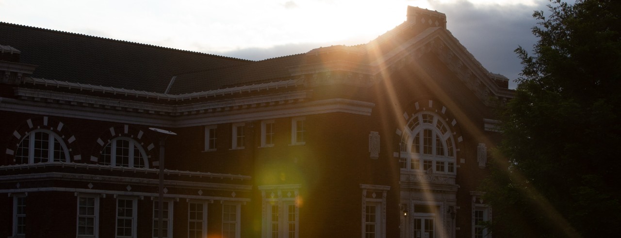 Sun setting on a CCM building