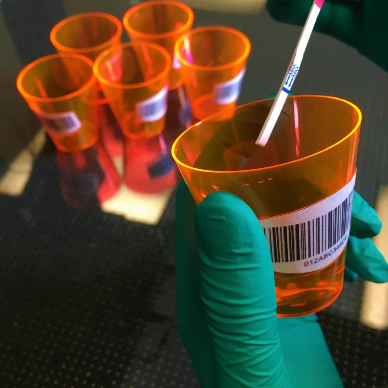 A test strip in a sample cup.