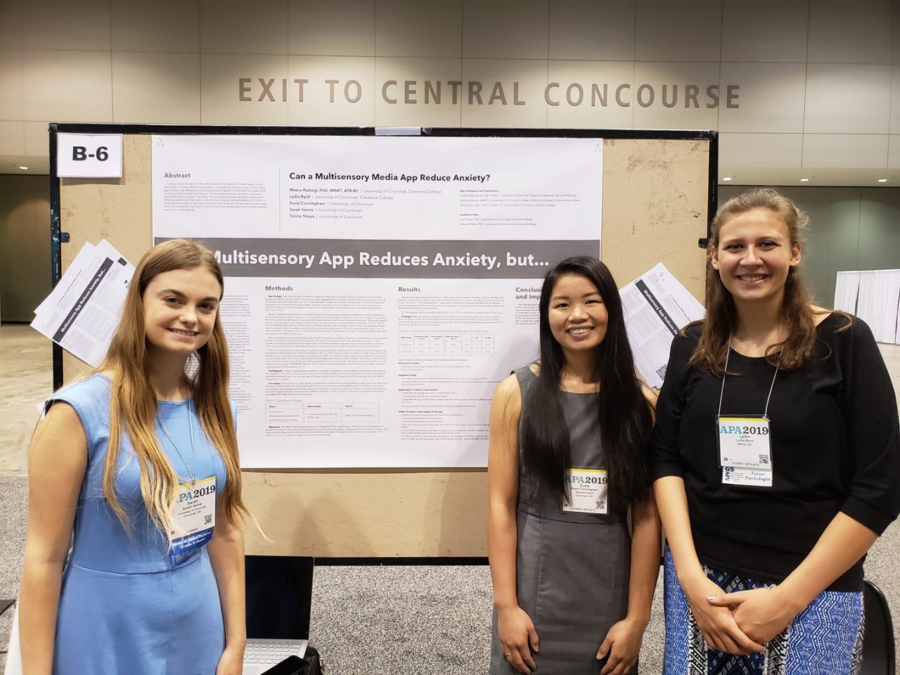 students pose with poster