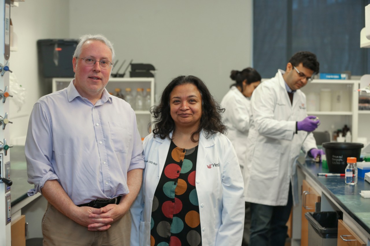 Left to right Dr. Daniel Krummel research associate professor and Dr. Soma Sengupta, UCGNI with in the background research assistant Eashika Chakraborty and Dr. Debanjam Bhattacharya shown here working in Dr. Soma Sengupta’s lab at Vontz building. UC/Joseph Fuqua II