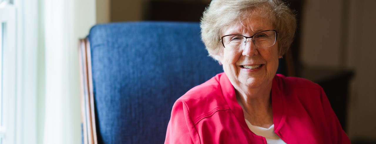 woman with glasses in blue chair