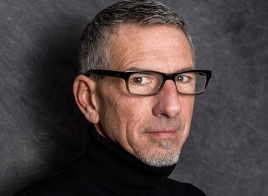 OIP Program Director Pierce Reed wearing glasses and looking at camera