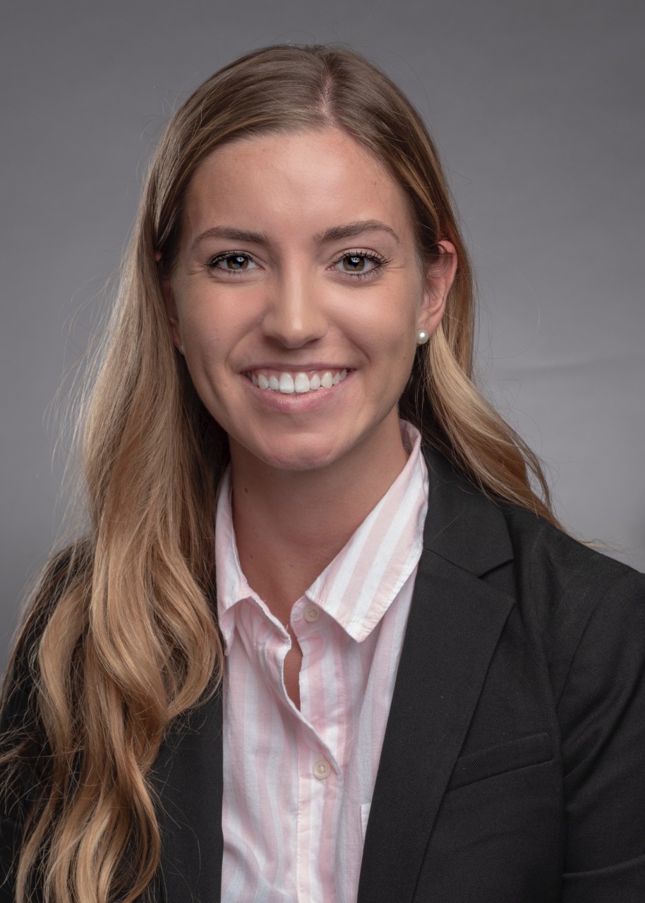 Woman in professional attire smiling at camera