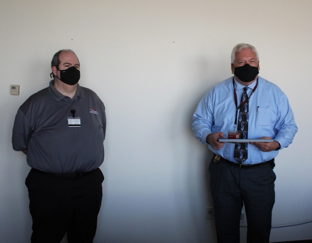 UC Public Safety Director James Whalen presents the Rave Mobile Safety SmartSave Award to Emergency Communications Dispatcher Ted Langdon.