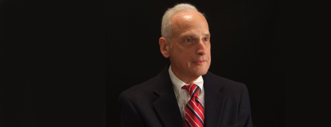 man in suit with red striped tie