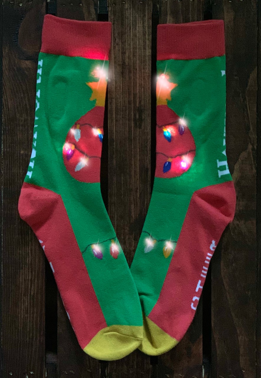Red and green holiday socks with twinkle lights