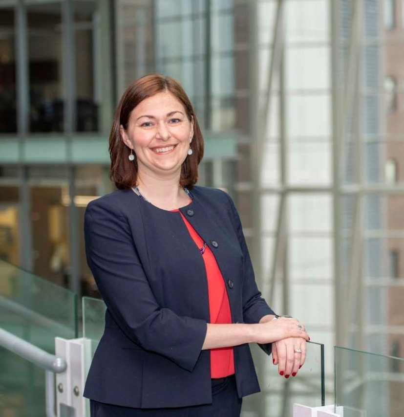 standing photo of UC reseracher Jennifer Brown. Photo taken on the steps of the CARE/Crawley building at the UC College of Medicine