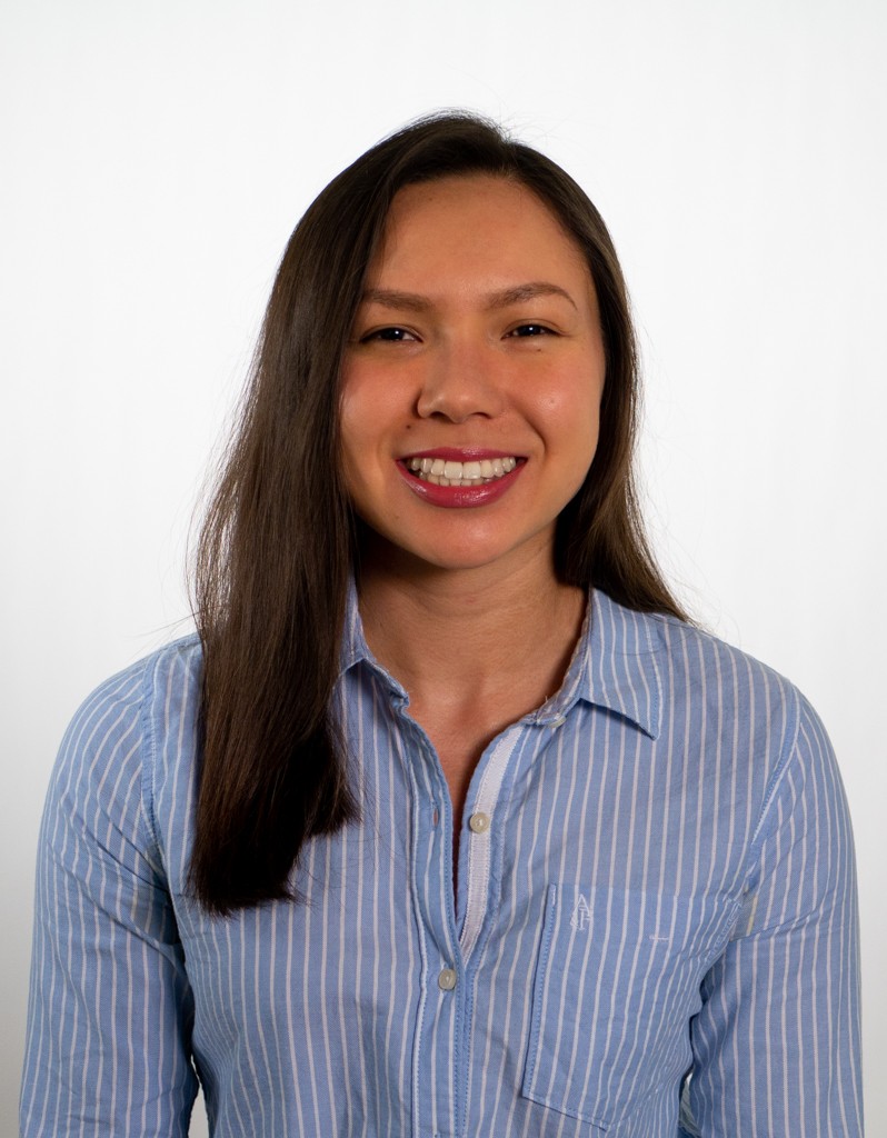 headshot of a young women wearing a light blue button down shirt