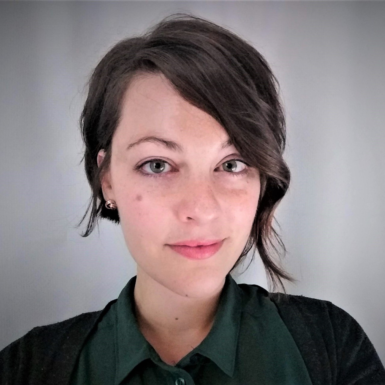 Headshot of Carlie Trott. Female, white, with short dark hair. 
