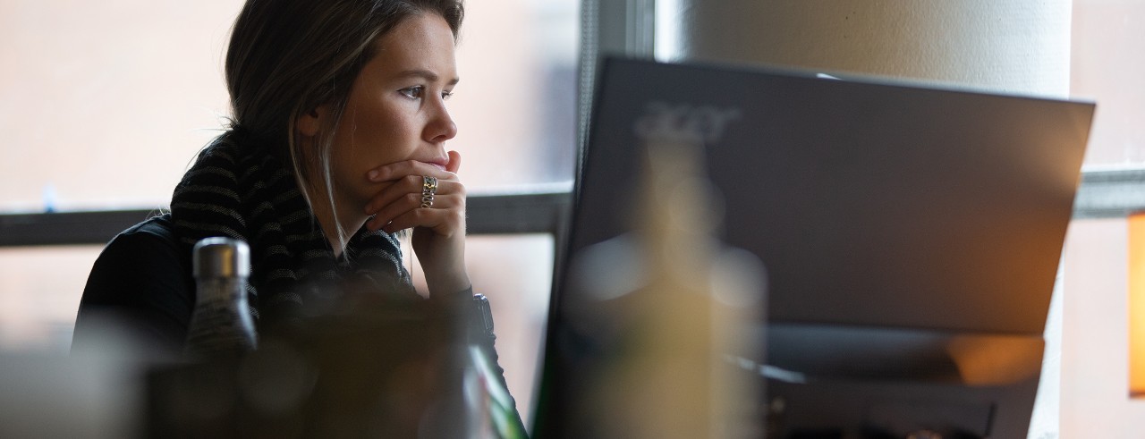 Student sits at a laptop computer.