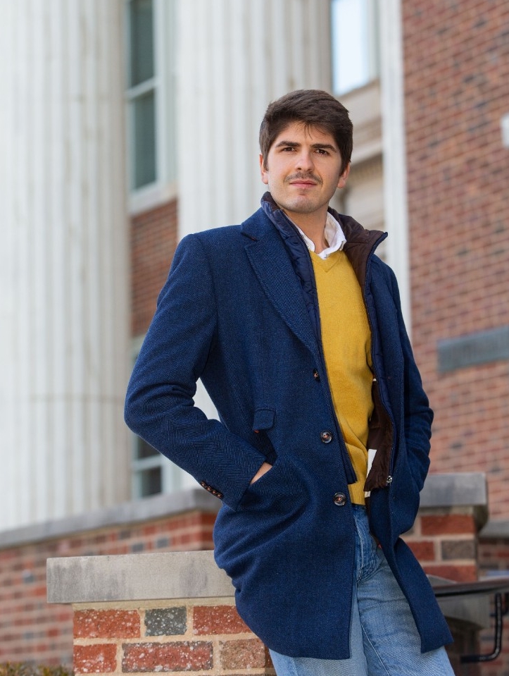 Javier Viaña stands on the steps of Baldwin Hall.