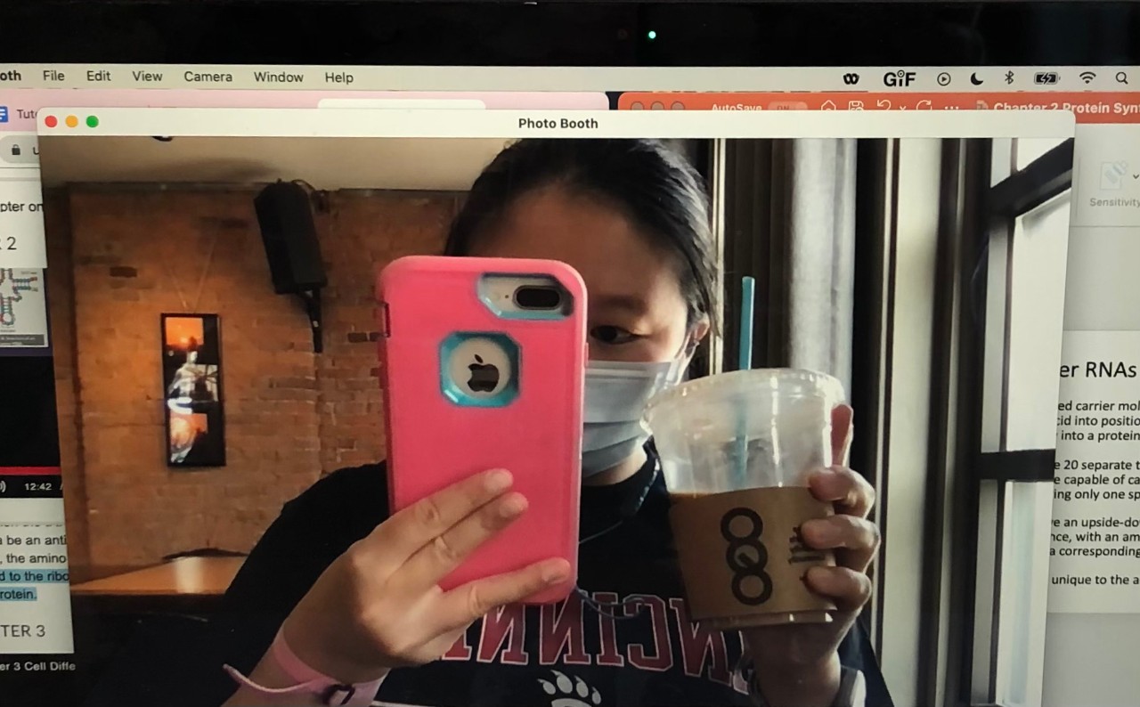 Katherine Zhong taking a selfie while holding an iced coffee