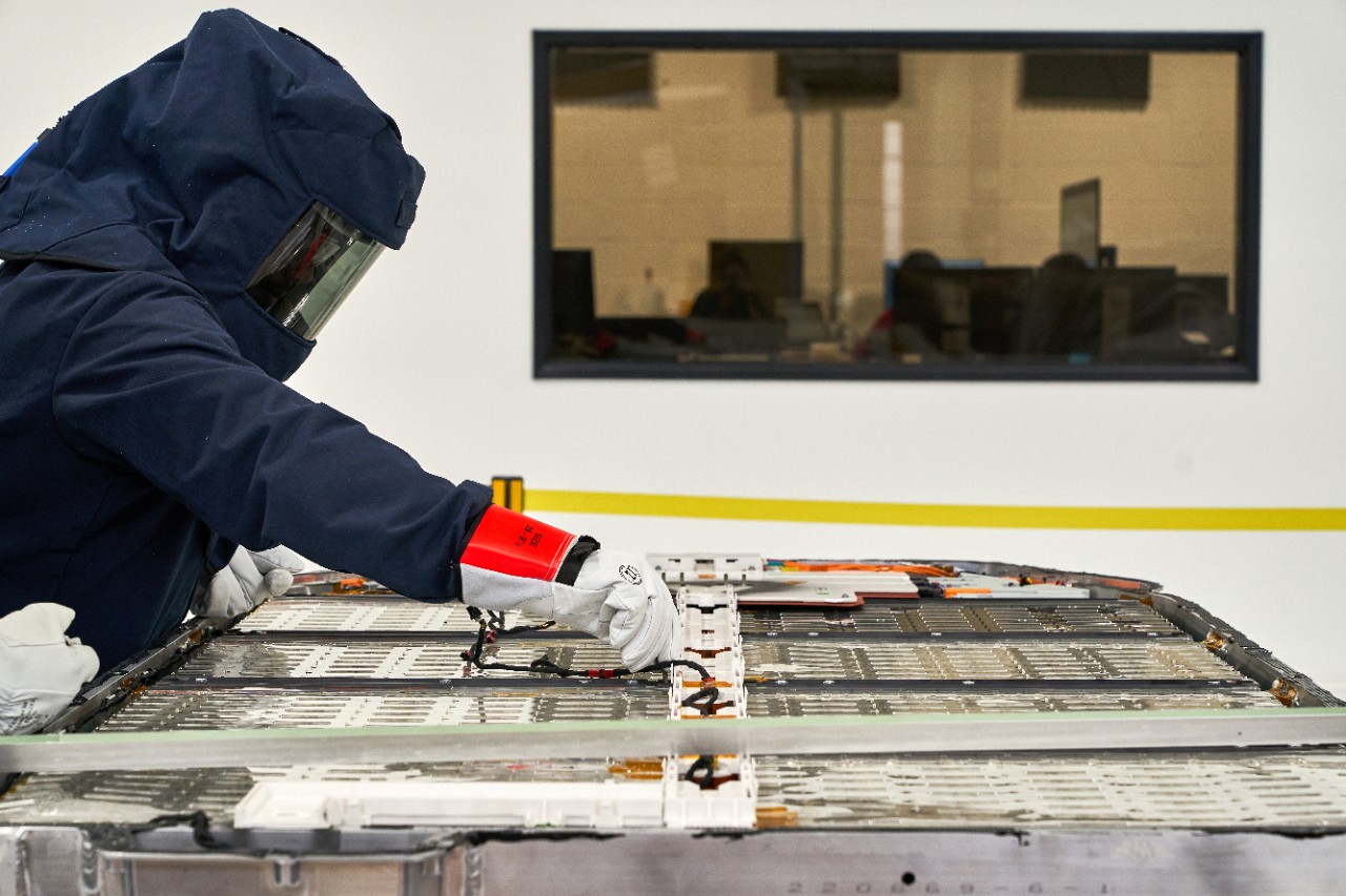 Rivian employee working with battery technology for electric adventure vehicles.