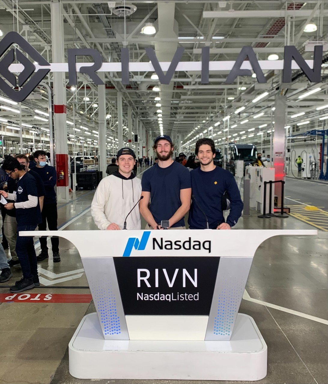William O'Callaghan, Carson Hock and Max Herrmann are shown at a Rivian manufacturing plan
