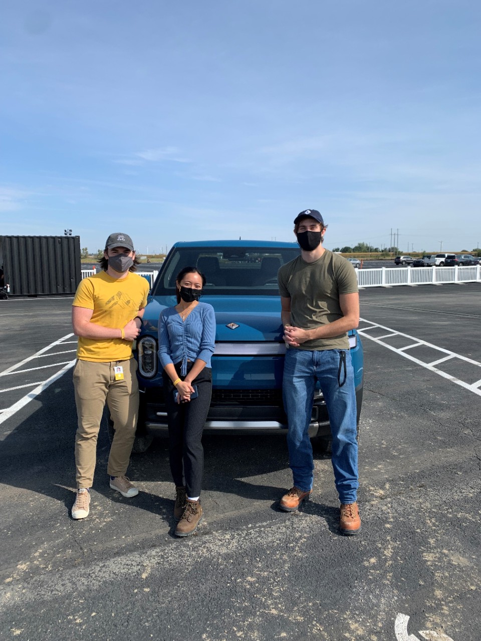 Will O'Callaghan, a Rivian colleague, and Carson Hock are shown at Rivian's manufacturing plant in Normal, Illinois