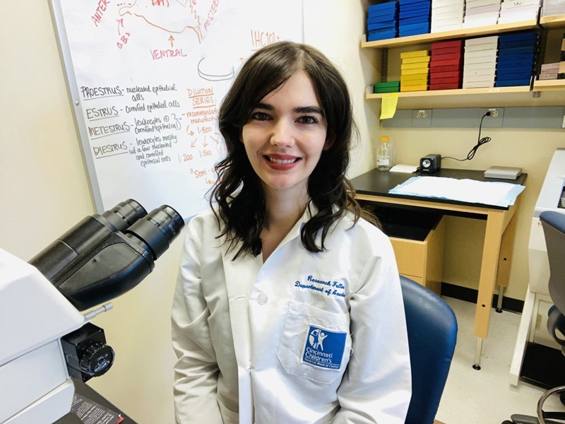 woman sitting by microscope