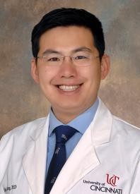 Headshot photo of Kyle Wang wearing a lab coat