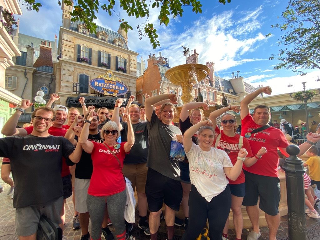 UC students and faculty make the UC gesture while in Disney World.