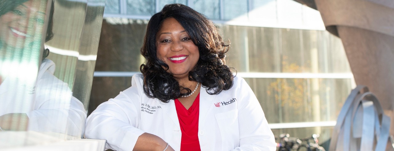 woman standing in front of a metal sculpture