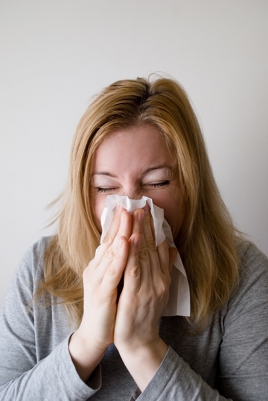 a woman blows her nose