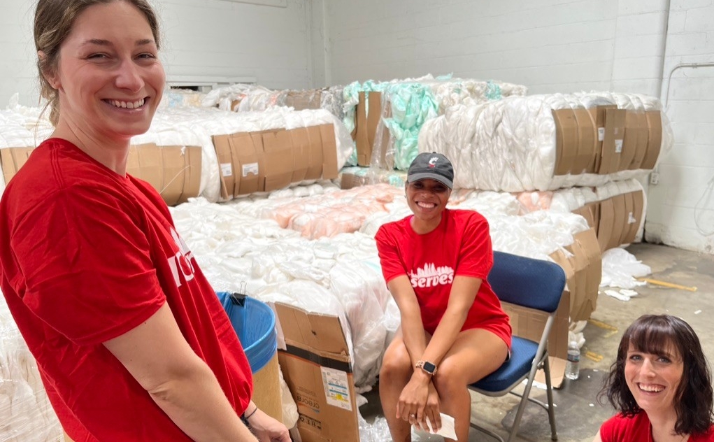 UC Online employees smile for a picture while serving at Matthew 25: Ministries