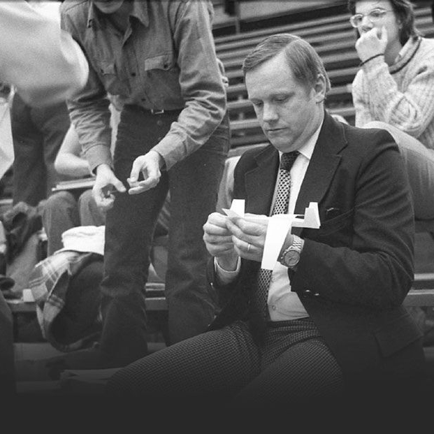 Neil Armstrong sits in the bleachers folding a paper airplane at the former UC Fieldhouse.