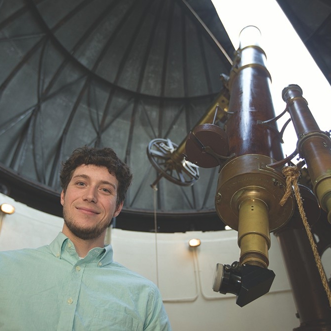 UC graduate Kevin Wagner at the Cincinnati Observatory. Wagner, an astrophysicist, discovered Scorpion-1b, a planet with three suns, last year at the European Southern Observatory in Chile. His discovery is expected to help astronomers refine theories about how new planets are formed. Wagner is a graduate of the McMicken College of Arts & Sciences.