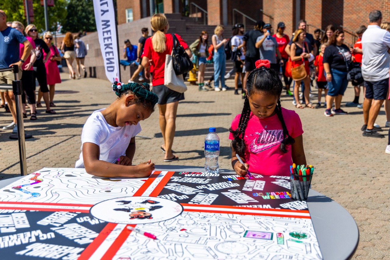 Younger family members participate in the coloring activity during check-in on Mainstreet on Friday, September 16th.