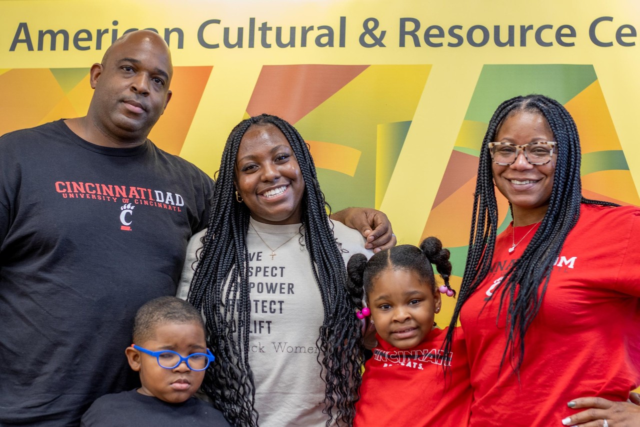 A family posed for a portrait photo at the AACRC Black Family Welcome on Friday, September 16, 2022. Families came by a background of the AACRC logo to take family photos, which was offered at the welcome event.