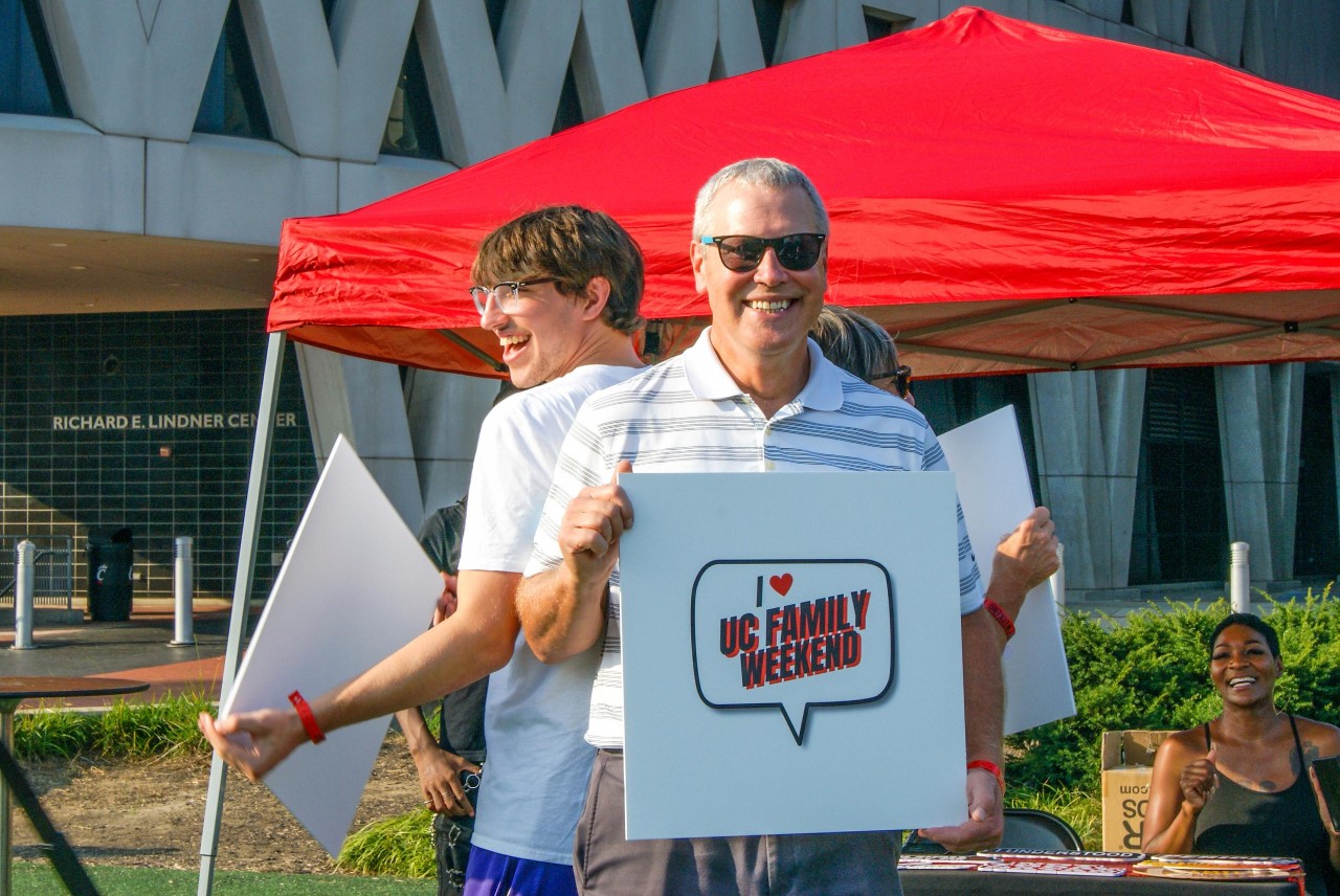 A first-year chemical engineering student and his family pose for the 360-degree camera offered at the UC Family Weekend BBQ on Friday, Sept. 16, 2022.