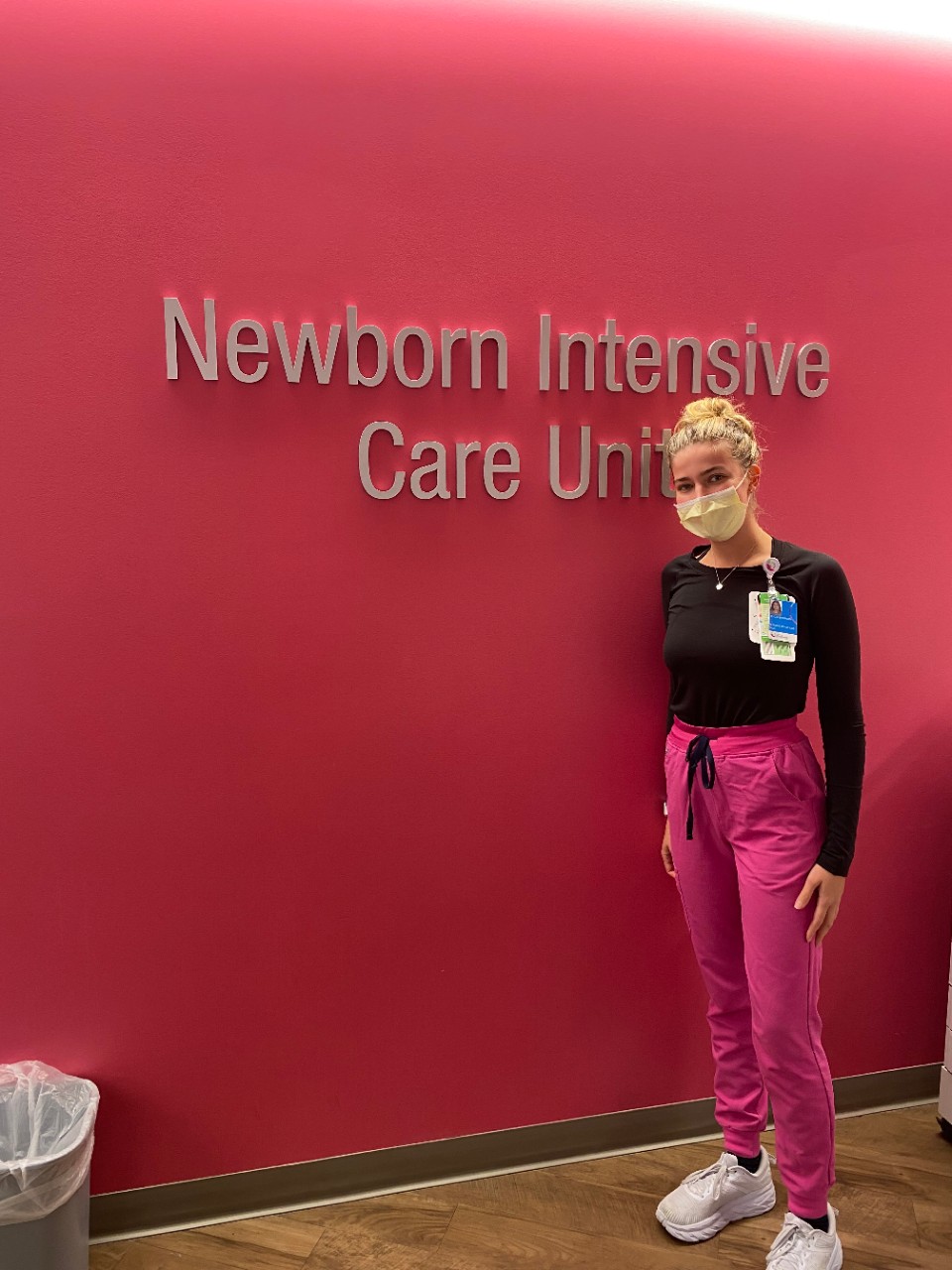 Alicia Shepard in front of a sign for the Cincinnati Children's NICU
