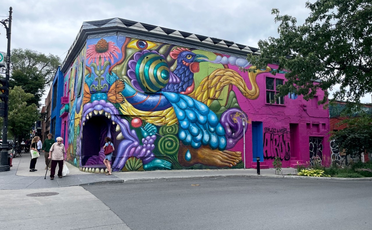A building completely painted with a swirling, colorful mural