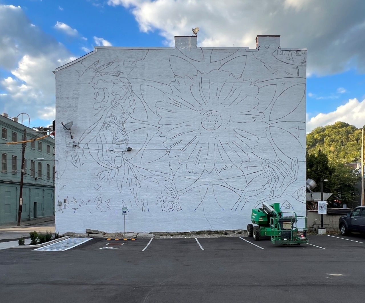 Side wall of the Dunlap Cafe. Painted white with stencil for mural to begin.
