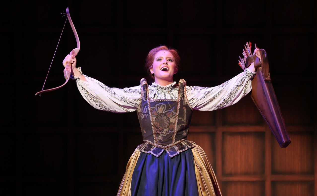 A student holds a bow and arrow in a dress rehearsal photo from CCM's Oct. 2022 production of "Something Rotten!" Photo/Mark Lyons