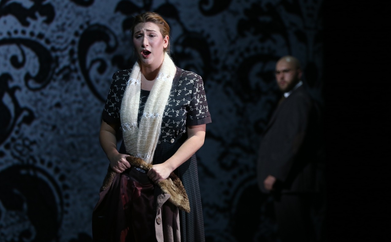 A woman sings in the foreground as a man looks on in the background in a dress rehearsal photo from CCM's Nov. 2022 production of "Dialogues of the Carmelites" Photo/Mark Lyons