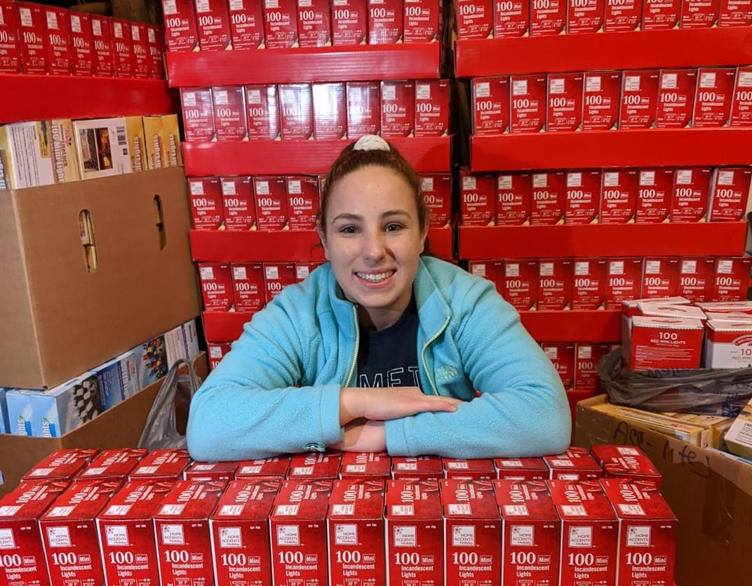 Oliva Messina in front of a shipment of lights. 