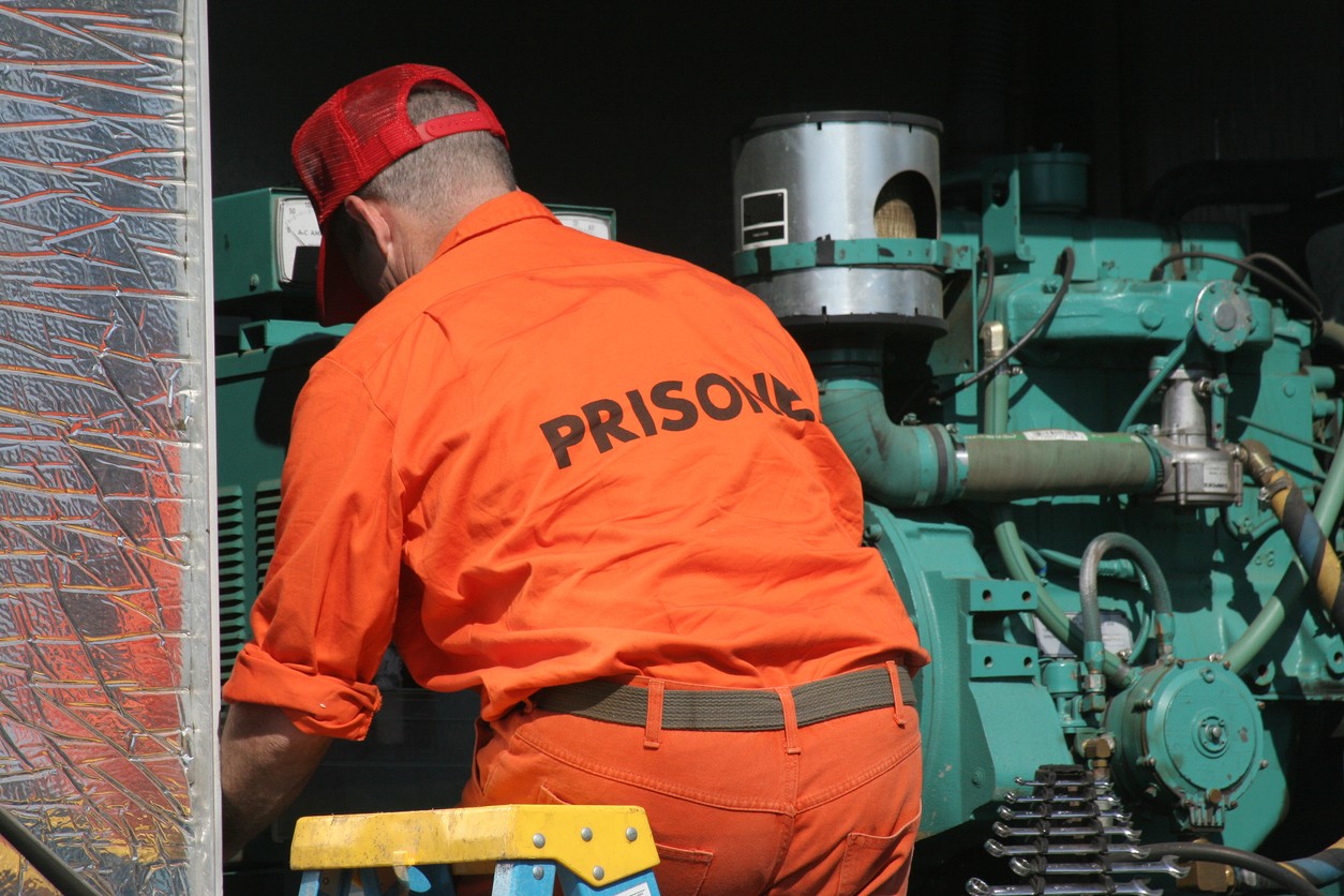 Photo of incarcerated person working in a prison