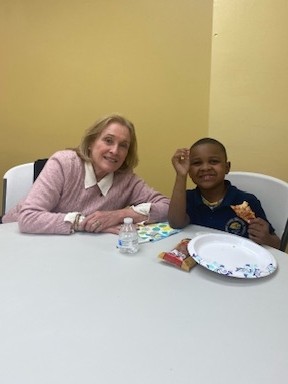  Susan Bourke spends time with a student during a tutoring session. 