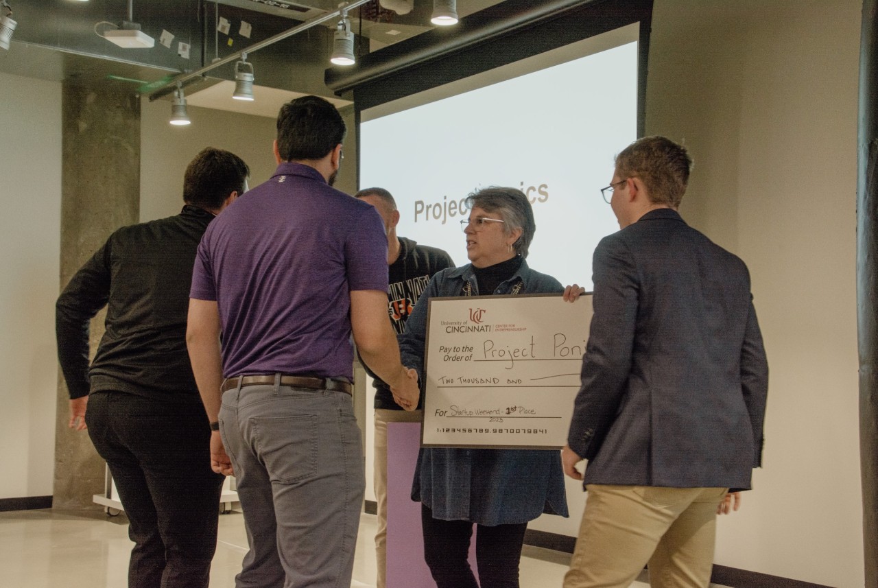Judges present award to one of the top winning teams during Startup Weekend. 