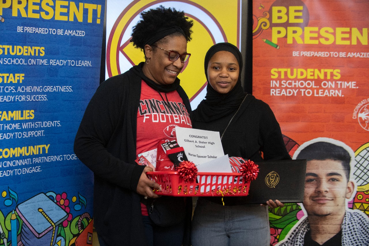 Jack Miner, Vice Provost for Enrollment Management surprised Djeneba Camara future UC Bearcats with Marian Spencer Scholarship awards at Dater High School Thursday January 26, 2023. Marian Spencer Scholarship  award students with full tuition, room and board and an all-expenses-paid study abroad experience from the University of Cincinnati. Photos by Joseph Fuqua II