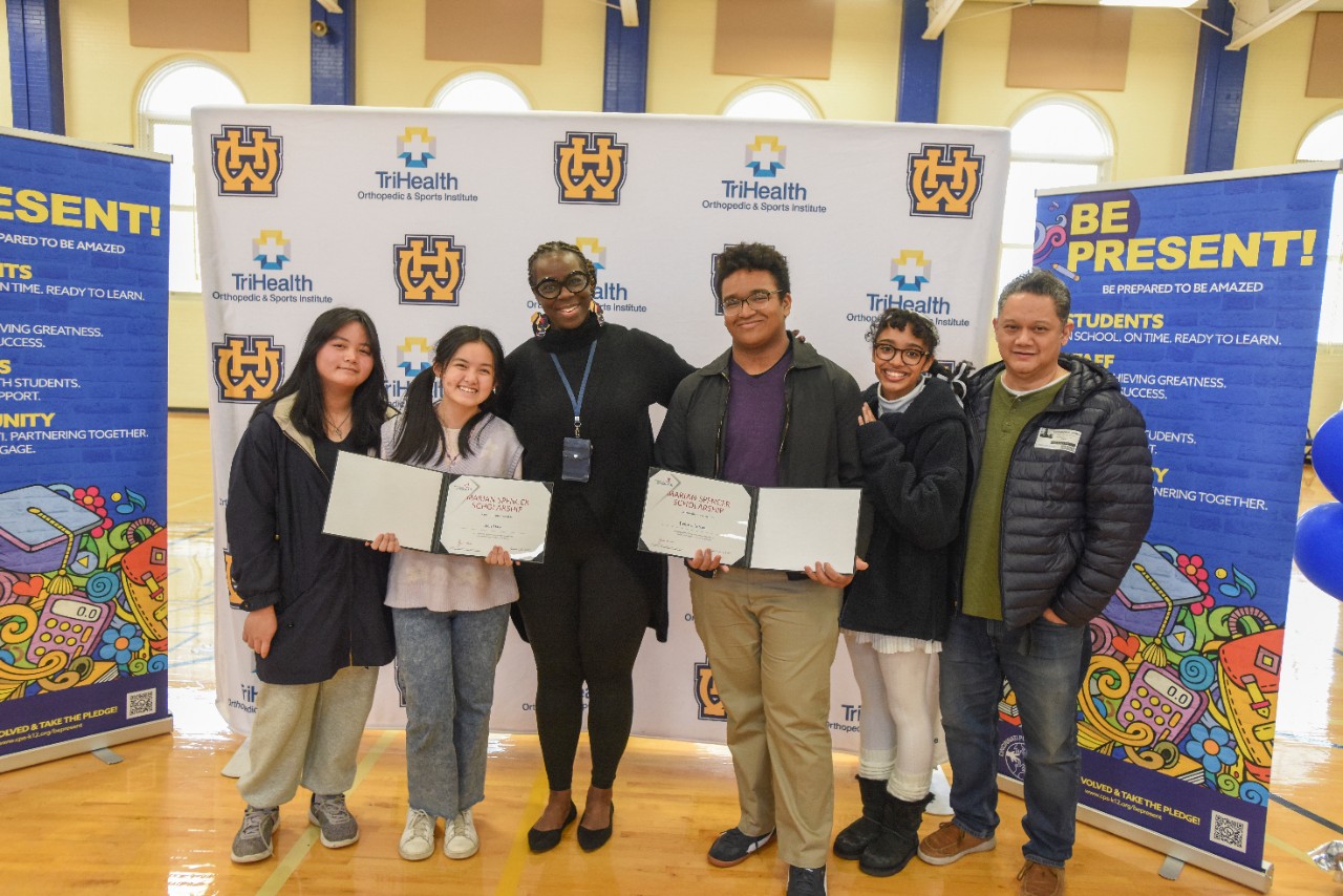 Uyen Dao and Joshua Lerma are joined by their families for the Marian Spencer announcement at Walnut Hills High School.